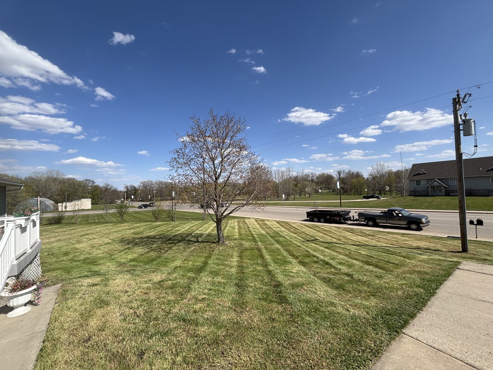 Lennes Lawn Co. work truck and freshly striped lawn